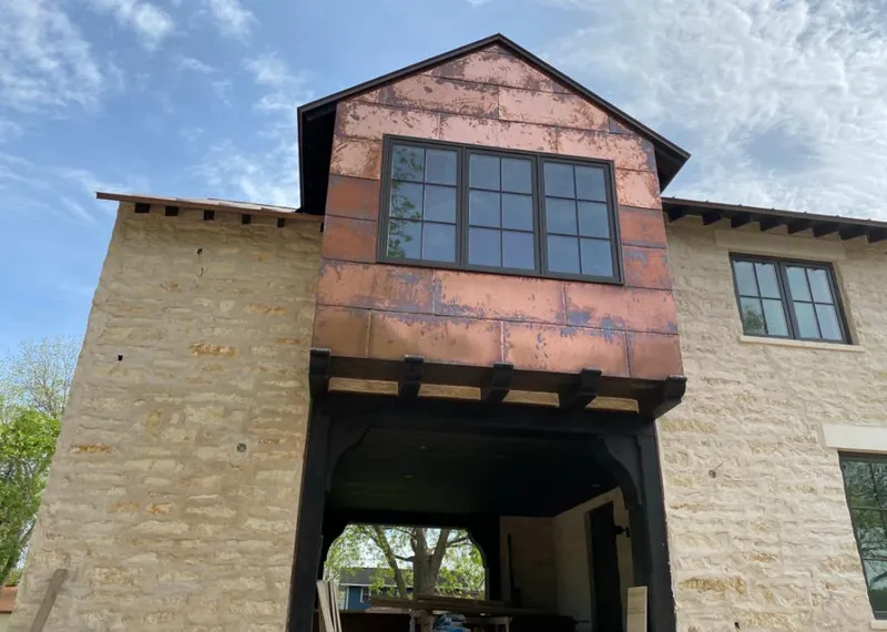 Copper metal panel facade on a stone building for Roof Repair in Kendallville