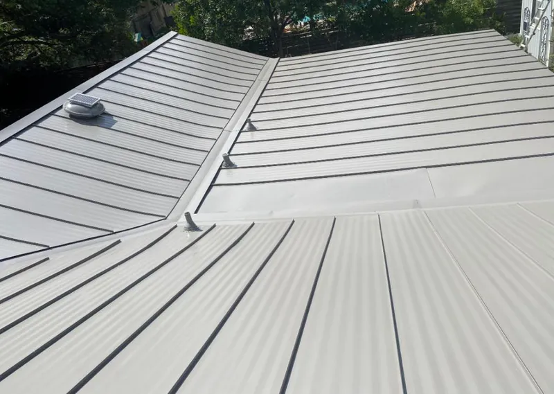Solar attic fan installed on a metal roof for Roof Ventilation in Kendallville